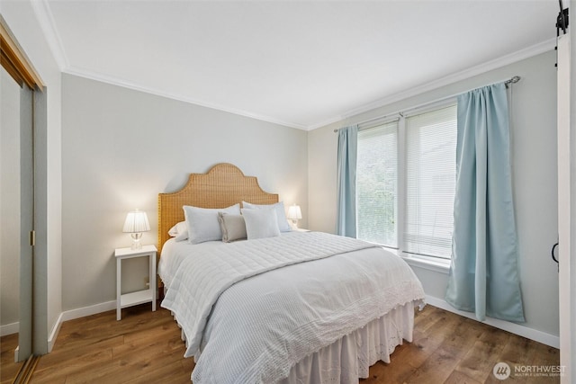 2828 Sunset Dr, Bellingham, WA 98225 - bedroom featuring crown molding, wood finished floors, baseboards, and a closet
