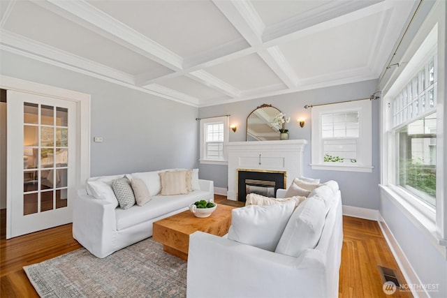 2828 Sunset Dr, Bellingham, WA 98225 - living room featuring coffered ceiling, beamed ceiling, a brick fireplace, baseboards, and wood finished floors