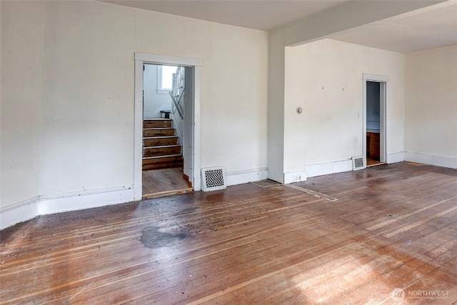 4604SW Lander St, Seattle, WA 98116 - spare room with stairway and hardwood / wood-style floors