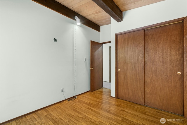 13008 Riviera Pl NE, Seattle, WA 98125 - unfurnished bedroom featuring wood finished floors, a closet, and wooden ceiling with exposed beams