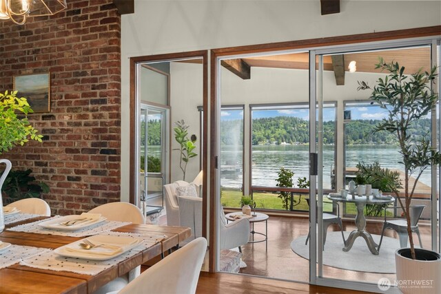 13008 Riviera Pl NE, Seattle, WA 98125 - dining space featuring wood finished floors, healthy amount of natural light, and a water view