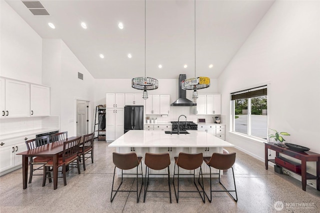 2495 River Rock Dr, Everson, WA 98247 - kitchen featuring high vaulted ceiling, refrigerator, wall chimney range hood, tasteful backsplash, and dark aggregate flooring