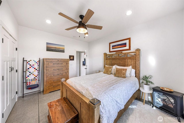 2495 River Rock Dr, Everson, WA 98247 - bedroom with baseboards, a wood stove, a ceiling fan, recessed lighting, and a closet