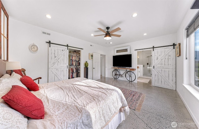 2495 River Rock Dr, Everson, WA 98247 - bedroom with a barn door, speckle patterned floor, recessed lighting, baseboards, and ensuite bath