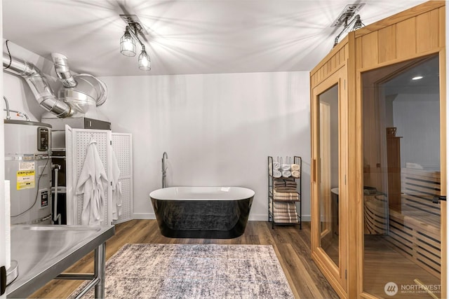 2495 River Rock Dr, Everson, WA 98247 - bathroom with a freestanding tub, wood finished floors, water heater, and baseboards