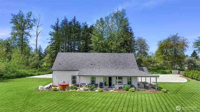 2495 River Rock Dr, Everson, WA 98247 - back of house with a lawn, a shingled roof, and covered porch