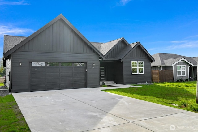 710 E 4th St, Nooksack, WA 98276 - view of front of property featuring board and batten siding, a garage, driveway, and a shingled roof