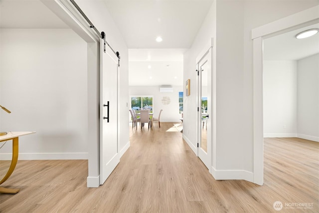 710 E 4th St, Nooksack, WA 98276 - hallway featuring light wood-type flooring, a barn door, baseboards, recessed lighting, and an AC wall unit