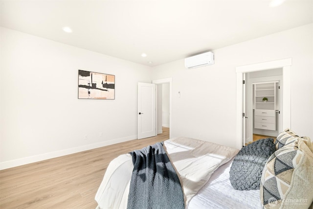 710 E 4th St, Nooksack, WA 98276 - bedroom featuring an AC wall unit, light wood-style floors, baseboards, and recessed lighting