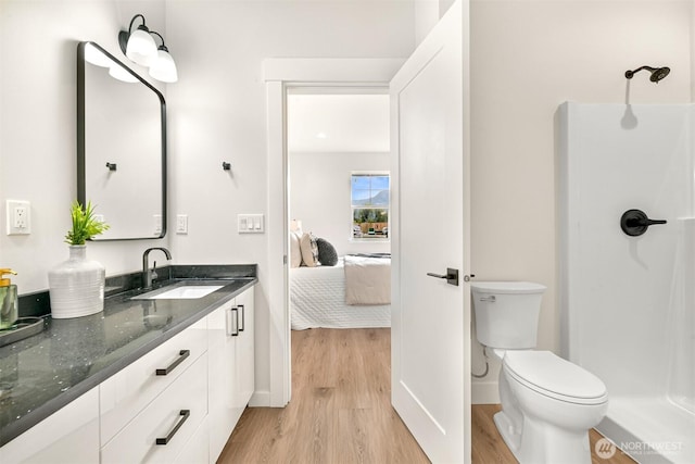 710 E 4th St, Nooksack, WA 98276 - full bath featuring wood finished floors, toilet, a shower, vanity, and ensuite bathroom