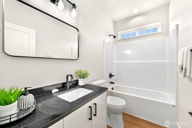 710 E 4th St, Nooksack, WA 98276 - full bath with toilet, washtub / shower combination, vanity, and wood finished floors