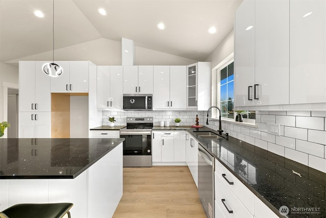 710 E 4th St, Nooksack, WA 98276 - kitchen featuring a sink, stainless steel appliances, white cabinetry, vaulted ceiling, and pendant lighting