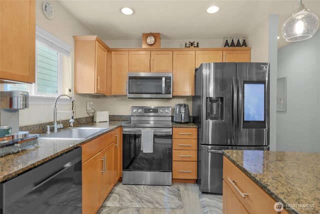 1921 76th Ave SE, Lake Stevens, WA 98258 - kitchen with stainless steel appliances, a sink, dark stone counters, hanging light fixtures, and recessed lighting