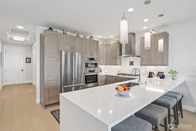 4907 Main St Unit 107, Tacoma, WA 98407 - kitchen featuring appliances with stainless steel finishes, a peninsula, baseboards, a sink, and a breakfast bar area