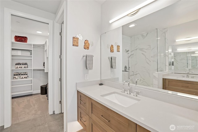 4907 Main St Unit 107, Tacoma, WA 98407 - full bath featuring a marble finish shower, a walk in closet, vanity, and tile patterned floors