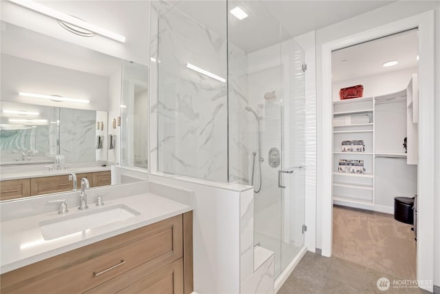 4907 Main St Unit 107, Tacoma, WA 98407 - bathroom featuring a marble finish shower, vanity, and a walk in closet