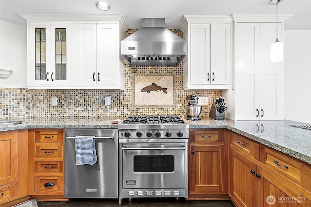 5758 Overlook Ave NE, Tacoma, WA 98422 - kitchen with stainless steel appliances, wall chimney range hood, glass insert cabinets, light stone counters, and white cabinets