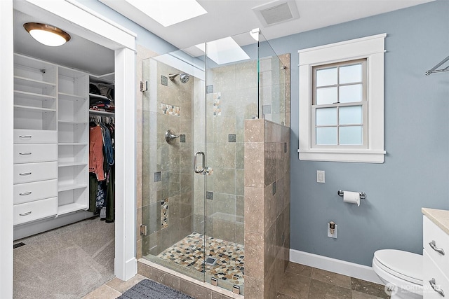 5758 Overlook Ave NE, Tacoma, WA 98422 - bathroom featuring a spacious closet, toilet, a stall shower, and baseboards