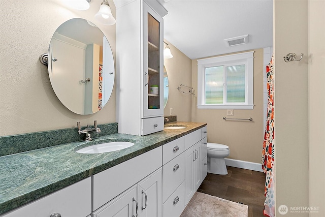 5758 Overlook Ave NE, Tacoma, WA 98422 - bathroom featuring double vanity, toilet, and baseboards
