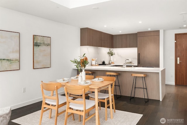 188 Bellevue Way NE Unit 307, Bellevue, WA 98004 - dining area featuring dark wood finished floors, recessed lighting, and baseboards