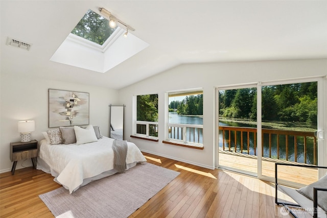 35029 37th Ave S, Auburn, WA 98001 - bedroom featuring rail lighting, a water view, a skylight, access to outside, and vaulted ceiling