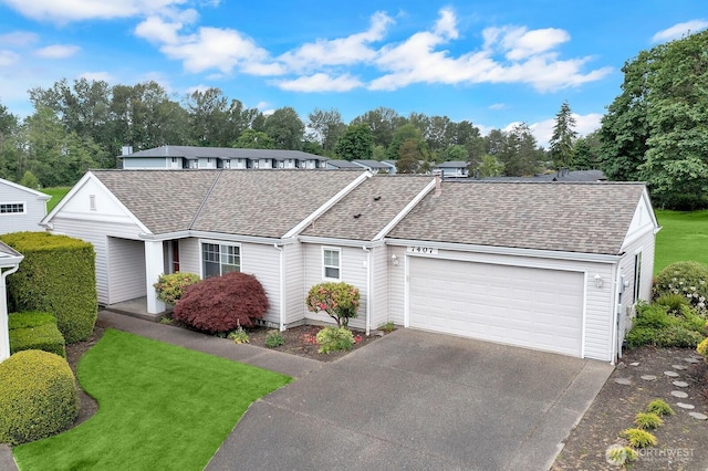 7407 143rd Avenue Ct E, Sumner, WA 98390 - view of front of property featuring a shingled roof, an attached garage, driveway, and a front lawn