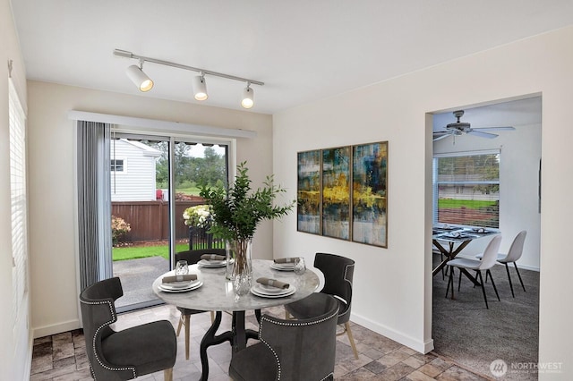 7407 143rd Avenue Ct E, Sumner, WA 98390 - dining space featuring baseboards and rail lighting