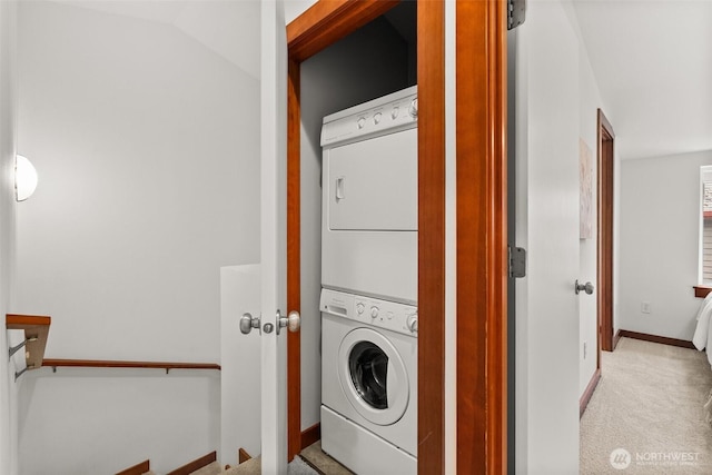 672 NE 40th St, Seattle, WA 98105 - laundry area featuring stacked washer / drying machine, carpet floors, and baseboards