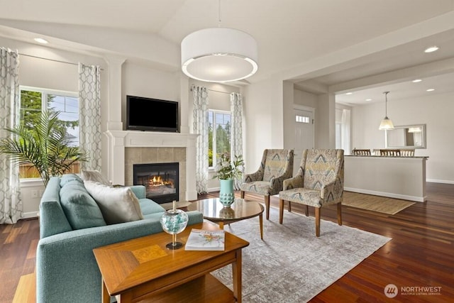 3707 Simmons Heights Ln SW, Tumwater, WA 98512 - living room with dark wood-style floors, a tile fireplace, recessed lighting, vaulted ceiling, and baseboards
