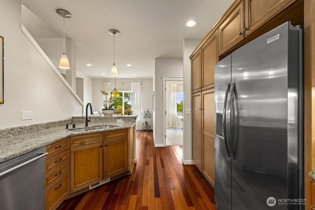 3707 Simmons Heights Ln SW, Tumwater, WA 98512 - kitchen featuring appliances with stainless steel finishes, a sink, brown cabinets, dark wood-style flooring, and recessed lighting