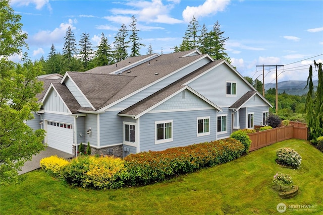 3707 Simmons Heights Ln SW, Tumwater, WA 98512 - rear view of house featuring an attached garage, roof with shingles, asphalt driveway, stone siding, and board and batten siding