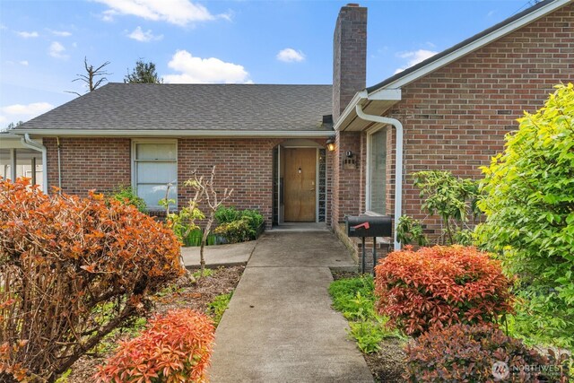180 Front St S, Issaquah, WA 98027 - property entrance with a chimney, brick siding, and a shingled roof