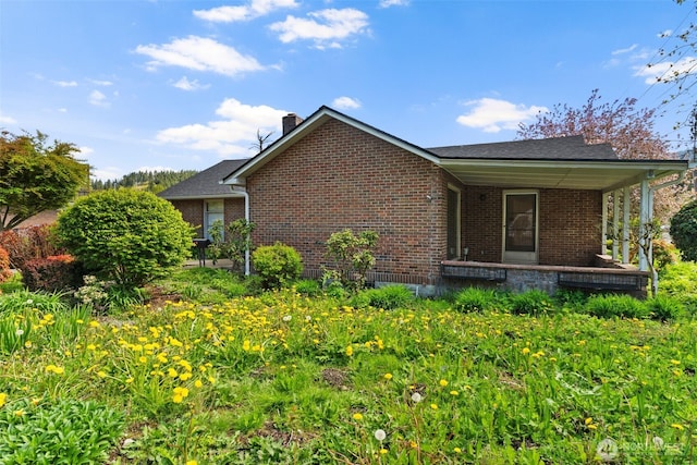 180 Front St S, Issaquah, WA 98027 - view of side of property with brick siding, a chimney, and covered porch