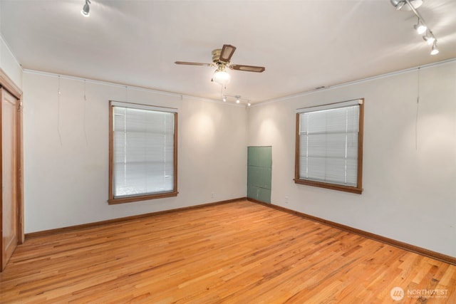 180 Front St S, Issaquah, WA 98027 - empty room with track lighting, wood finished floors, ceiling fan, and baseboards