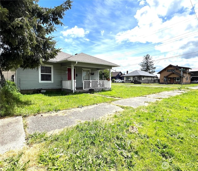 519 28th St, Hoquiam, WA 98550 - bungalow with covered porch, a front lawn, and roof with shingles