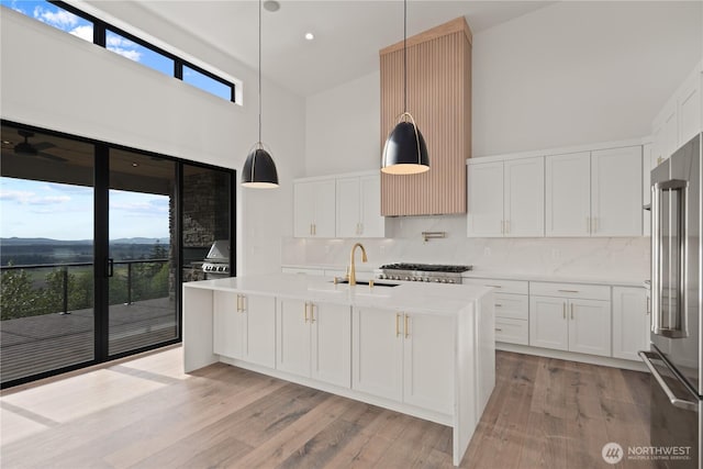 20519 Benson Ridge Ln, Mount Vernon, WA 98274 - kitchen featuring high vaulted ceiling, high quality fridge, light countertops, decorative backsplash, and a sink