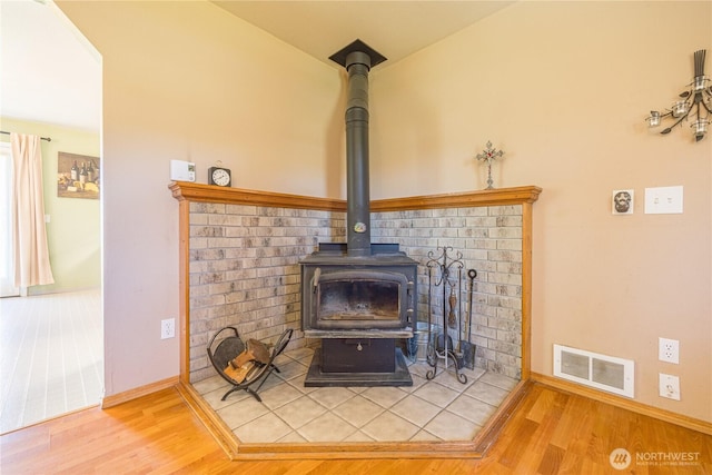1160 Cays Rd, Sequim, WA 98382 - detailed view of a wood stove, wood finished floors, and baseboards