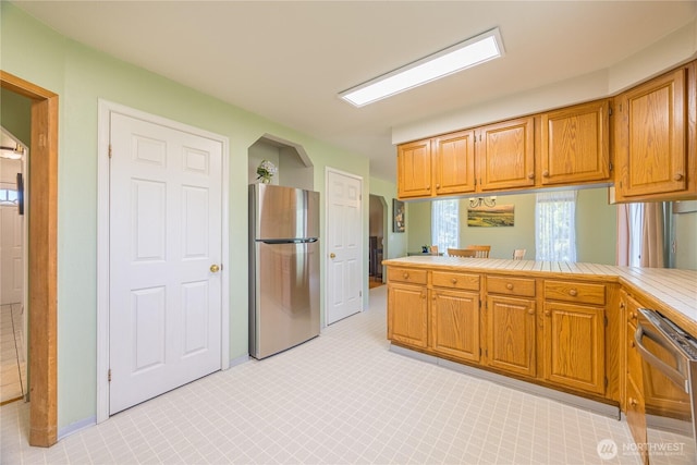 1160 Cays Rd, Sequim, WA 98382 - kitchen featuring stainless steel appliances, a peninsula, and brown cabinetry