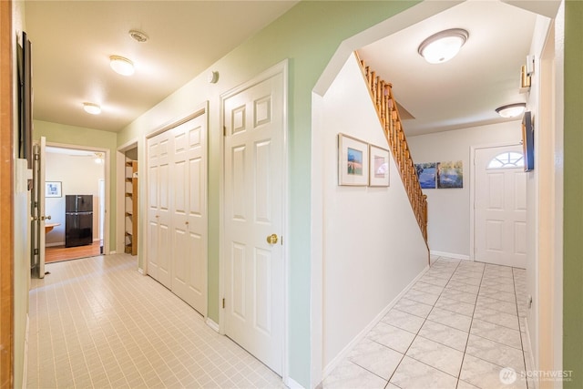 1160 Cays Rd, Sequim, WA 98382 - hall with light tile patterned flooring, baseboards, and stairs