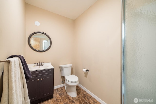1160 Cays Rd, Sequim, WA 98382 - bathroom with toilet, vanity, baseboards, and a shower with shower door