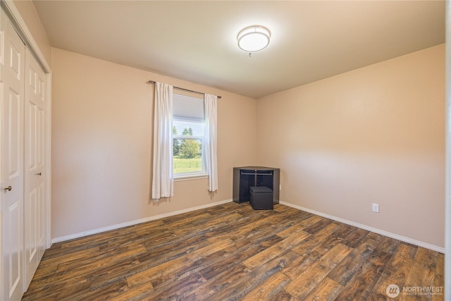 1160 Cays Rd, Sequim, WA 98382 - unfurnished bedroom with dark wood-style floors, a closet, and baseboards