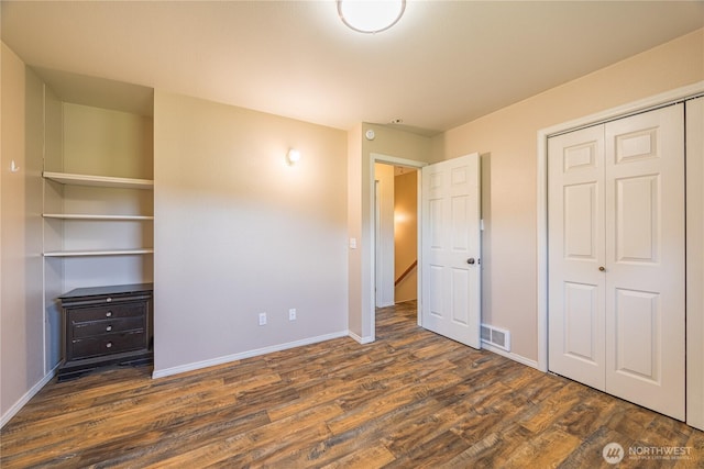 1160 Cays Rd, Sequim, WA 98382 - unfurnished bedroom with dark wood-style floors, a closet, and baseboards
