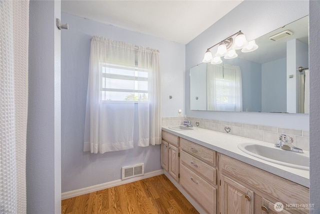 1160 Cays Rd, Sequim, WA 98382 - bathroom with wood finished floors, double vanity, and baseboards