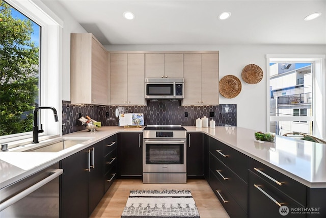 2817 Franklin Ave E Unit A, Seattle, WA 98102 - kitchen with appliances with stainless steel finishes, plenty of natural light, a sink, light countertops, and recessed lighting