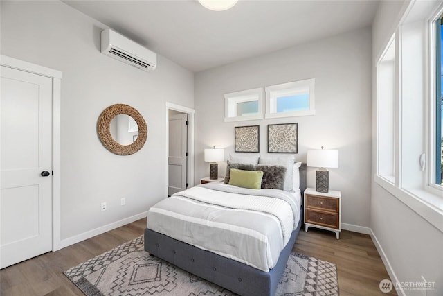 2817 Franklin Ave E Unit A, Seattle, WA 98102 - bedroom with a wall unit AC, wood finished floors, and baseboards