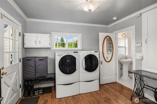 10918 159th Ave SE, Snohomish, WA 98290 - laundry room with washing machine and clothes dryer, cabinet space, ornamental molding, and dark wood finished floors