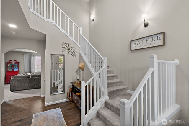 4415 Goldcrest Dr NW, Olympia, WA 98502 - stairs with arched walkways, wood finished floors, and baseboards