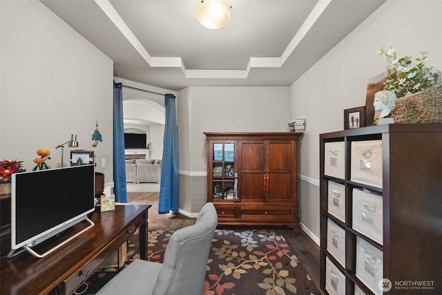 4415 Goldcrest Dr NW, Olympia, WA 98502 - office area with arched walkways, a tray ceiling, wood finished floors, and baseboards