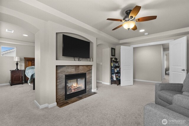 4415 Goldcrest Dr NW, Olympia, WA 98502 - carpeted living room with a tile fireplace, ceiling fan, baseboards, and recessed lighting