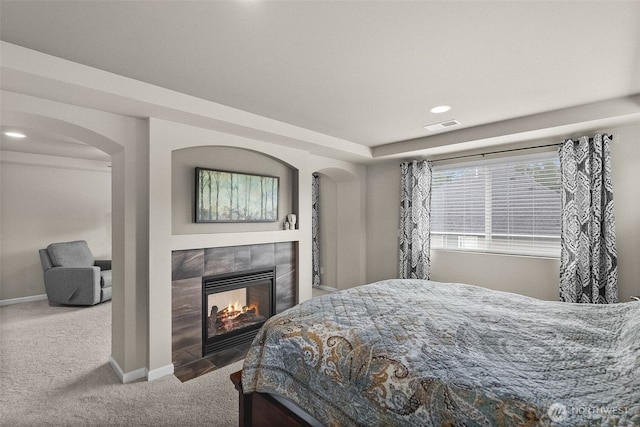 4415 Goldcrest Dr NW, Olympia, WA 98502 - bedroom with carpet, arched walkways, a tiled fireplace, recessed lighting, and baseboards